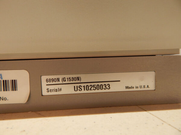 A label with serial number on a beige background.